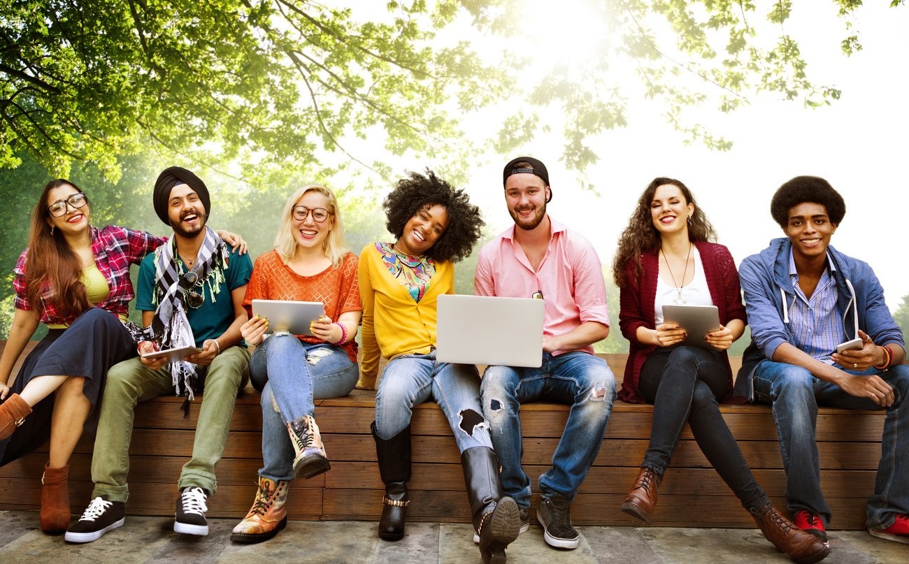 A group of people sitting on a bench

Description automatically generated